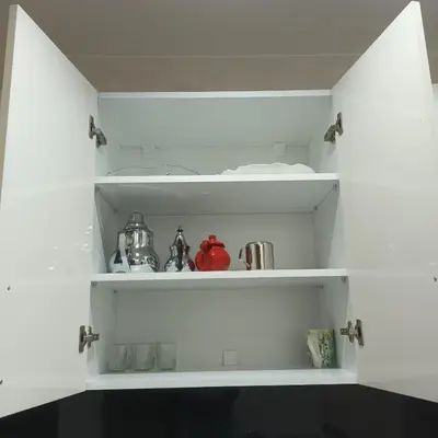 a white pantry shelf with items on it at Modern 2-Bedroom Family Flat in Central Marrakech in Marrakech