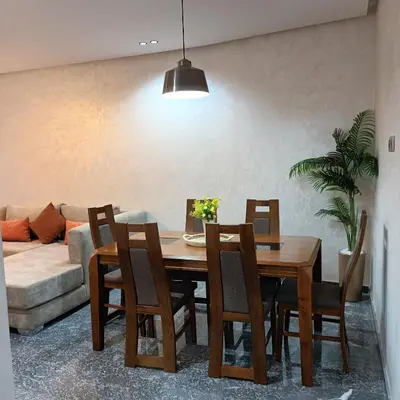 a dining room table with chairs and a couch at Modern 2-Bedroom Family Flat in Central Marrakech in Marrakech
