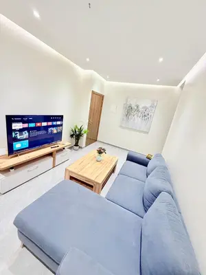 a living room with a blue couch and a tv at N47 Confortable Près De Gueliz FAMILY in Marrakech
