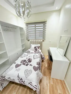 a bedroom with a bed and a desk and a chandelier at N47 Confortable Près De Gueliz FAMILY in Marrakech