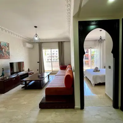 a large living room with a bed and a couch at In Gueliz, Chic and Ethnic with a palm view in Marrakech