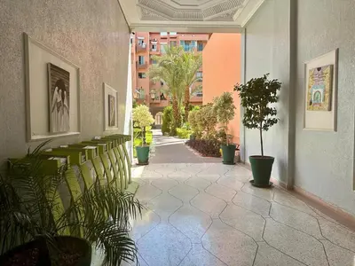 a hallway with potted plants in a building at Modern & Chic Duplex Near The Center, Brand New in Marrakech