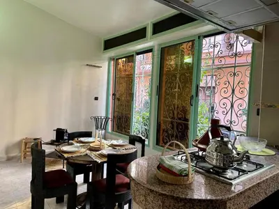 a kitchen with a table and chairs and a stove at Modern & Chic Duplex Near The Center, Brand New in Marrakech