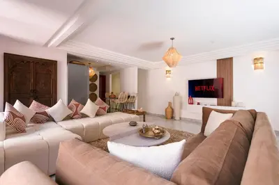 a living room with a couch and a table at Gueliz's Sun Marrakesh Centre in Marrakech