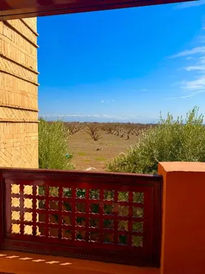 a view from the balcony of a house with a fence at Appartement Belle vue sur l'atlas in Marrakech
