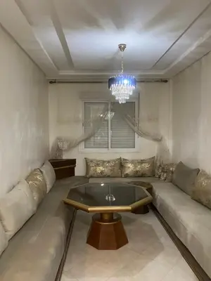 a living room with a couch and a table at Marrakech Bassatine targa in Marrakech