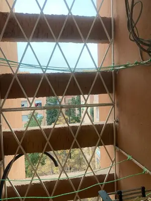 a window with a view of a building at Marrakech Bassatine targa in Marrakech