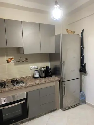 a kitchen with a stainless steel refrigerator and a stove at Marrakech Bassatine targa in Marrakech