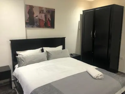 a bedroom with a large bed with white sheets and pillows at APPARTEMENT MODERNE AU CENTRE m in Marrakech