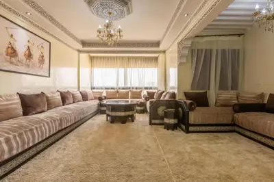 a large living room with couches and a chandelier at ELEGANT APARTMENT DOWNTOWN m in Marrakech