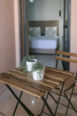 a wooden table with three potted plants on it at Signature Suite Private Pool in Marrakech