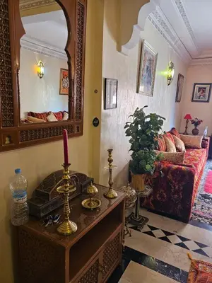 a living room with a mirror and a table with a candle at Warda-A-31 Rue Abi Hanifa in Marrakech