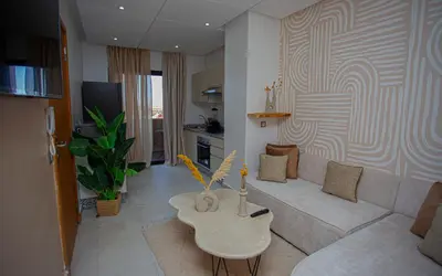 a living room with a couch and a table at Smart Loft in Marrakech