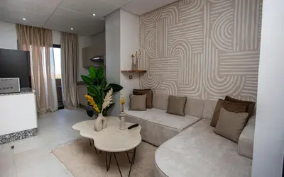 a living room with a couch and a table at Smart Loft in Marrakech