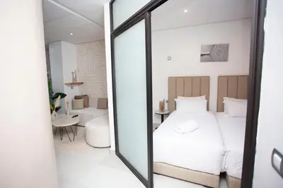 a bedroom with a bed and a mirror at Smart Loft in Marrakech
