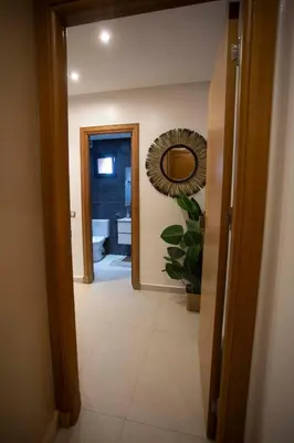 a hallway with a mirror and a bathroom at Smart Loft in Marrakech
