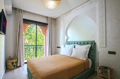 a bedroom with a bed with a large window at Villa Dar Cactus piscine chauffée in Marrakech