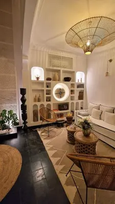 a living room with a couch and a table and chairs at Dar Baraï in Marrakech