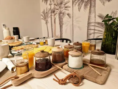 a table topped with jars of honey and orange juice at Dar Baraï in Marrakech