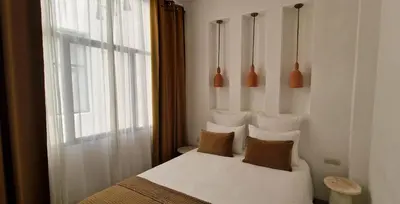 a bedroom with a bed with pillows and a window at Dar Baraï in Marrakech
