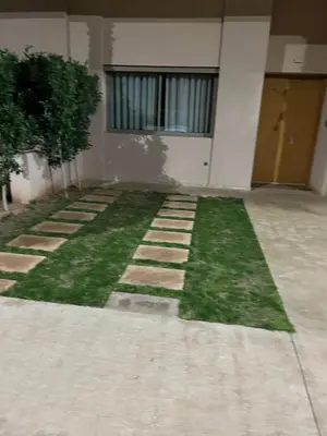 a house with a lawn in front of it at Villa Tazinsky in Hbl Hmid