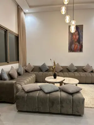 a living room with a couch and a table at Villa Tazinsky in Hbl Hmid