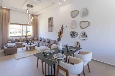 a living room with a table and chairs at Villa Tazinsky in Hbl Hmid