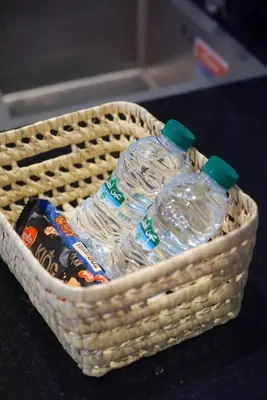 a basket with two bottles of water in it at Piscine- Résidence haut de Gamme in Marrakech