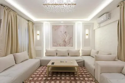 a living room with a white couch and a table at Majorelle Retreat in Marrakech