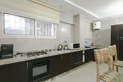 a kitchen with black and white appliances and a window at Majorelle Retreat in Marrakech