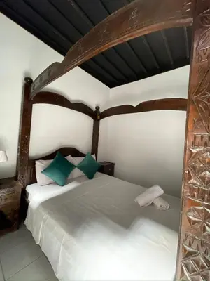 a bedroom with a large wooden bed in a room at Riad Zitoune in Marrakech