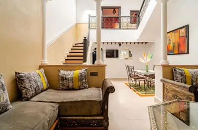 a living room with a couch and a staircase at Riad Zitoune in Marrakech