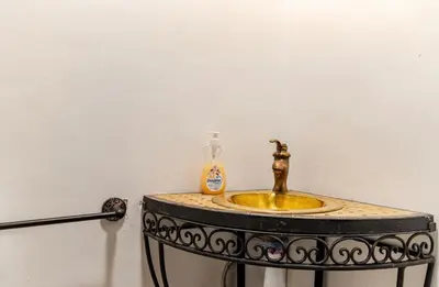 a bathroom sink with a soap dispenser on it at Riad Zitoune in Marrakech