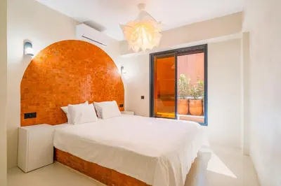 a bedroom with a large bed and a window at Exclusive Family Appartement in Marrakech