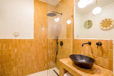 a bathroom with a black sink and a shower at Exclusive Family Appartement in Marrakech