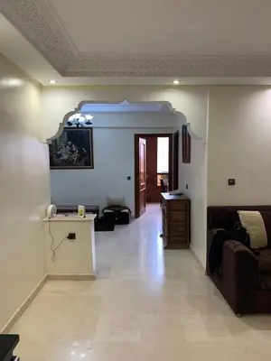 a living room with a couch and a table at Asmae in Marrakech
