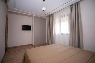 a bedroom with a bed and a window at Luxury 2-Bedroom Apartment with Balcony - Heart of Gueliz in Marrakech