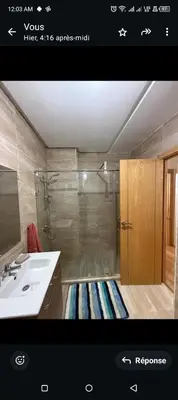 a bathroom with a shower and a sink at Spacieux appartement familial 2 in Marrakech