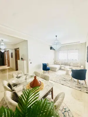 a living room with a table and a couch at Charmant Appartement 2 Room Wifi Marrakech in Marrakech