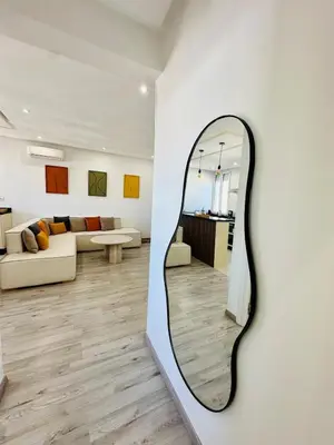 a mirror on a wall in a living room at Cosy Appartement 2 Room Wifi Marrakech in Marrakech