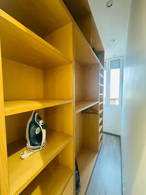 a closet with wooden shelves and a helmet in it at Cosy Appartement 2 Room Wifi Marrakech in Marrakech