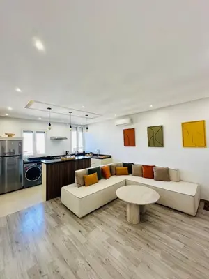 a living room with a couch and a table at Cosy Appartement 2 Room Wifi Marrakech in Marrakech