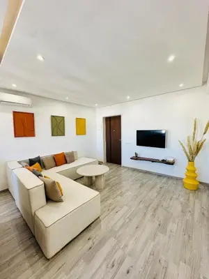 a living room with a couch and a tv at Cosy Appartement 2 Room Wifi Marrakech in Marrakech