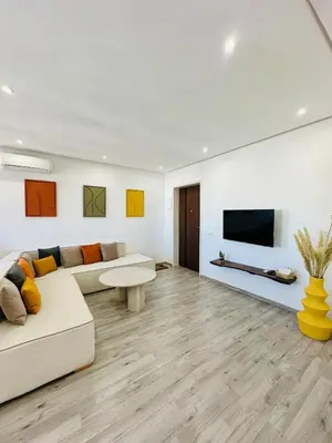 a living room with two white couches and a tv at Cosy Appartement 2 Room Wifi Marrakech in Marrakech