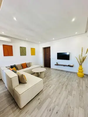 a living room with a couch and a tv at Cosy Appartement 2 Room Wifi Marrakech in Marrakech