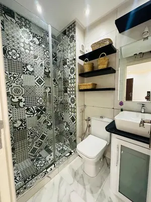 a bathroom with a shower and a toilet and a sink at Cosy Appartement 2 Room Wifi Marrakech in Marrakech