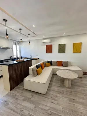 a living room with a couch and a table at Cosy Appartement 2 Room Wifi Marrakech in Marrakech