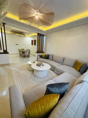 a living room with a couch and a table at Elegant 2 Bedrooms with Pool & Wi-Fi Marrakech in Marrakech