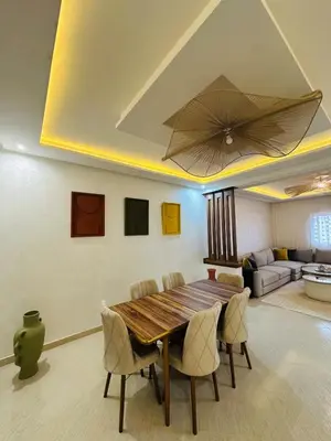 a dining room with a wooden table and chairs at Elegant 2 Bedrooms with Pool & Wi-Fi Marrakech in Marrakech