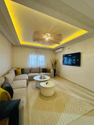 a living room with a couch and a ceiling fan at Elegant 2 Bedrooms with Pool & Wi-Fi Marrakech in Marrakech